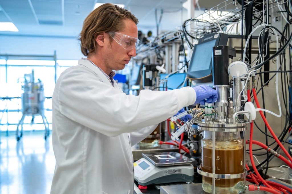 A researcher operating a bioreactor in ABPDU's lab